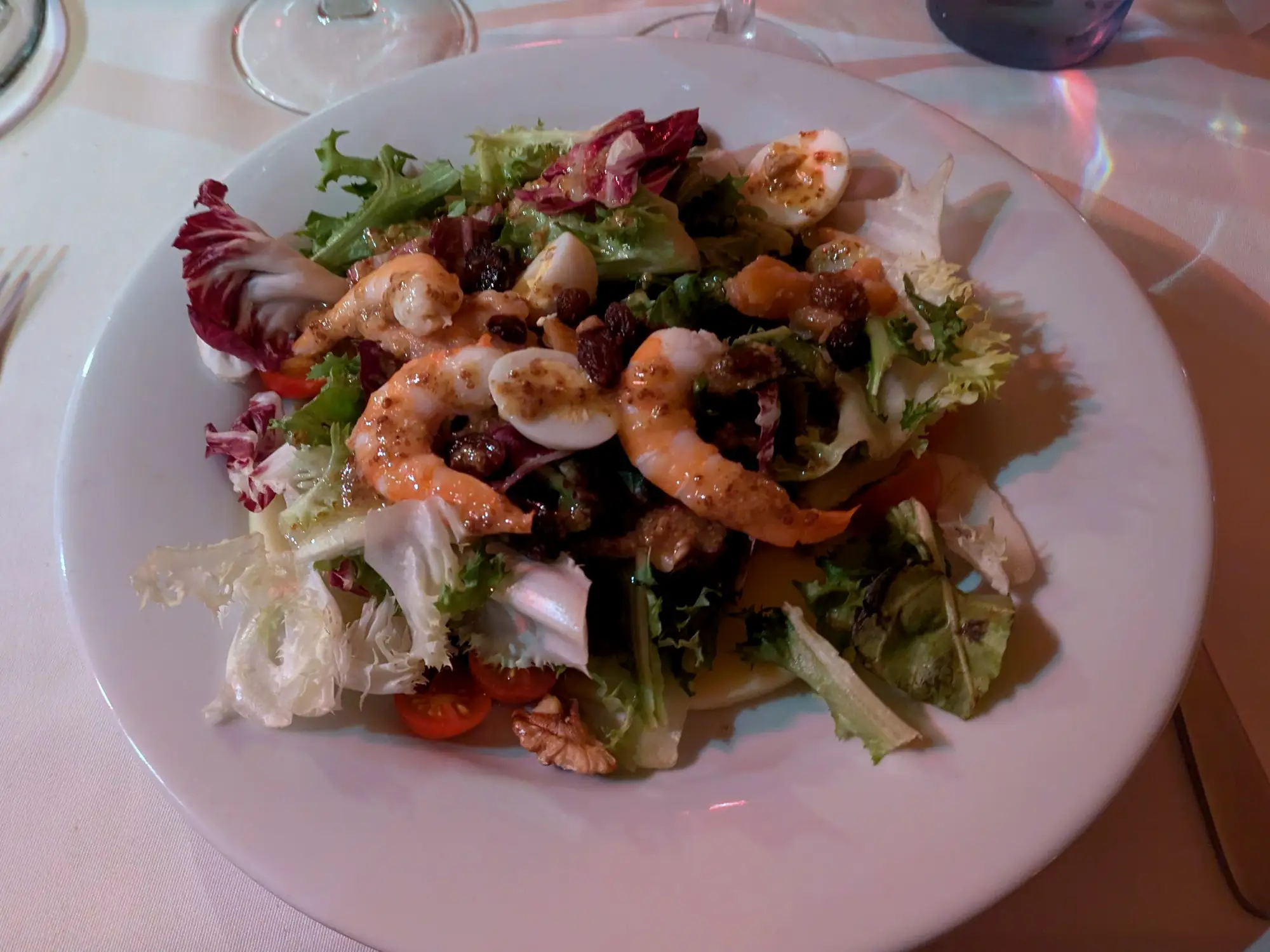 Ensalada de hojas variadas con langostinos, huevo de codorniz, pasas y nueces